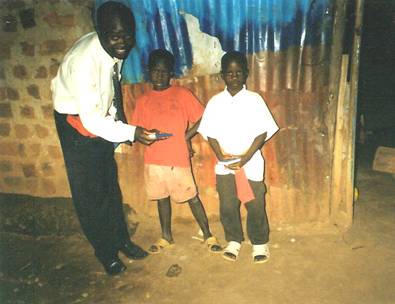 Mike giving bibles to children